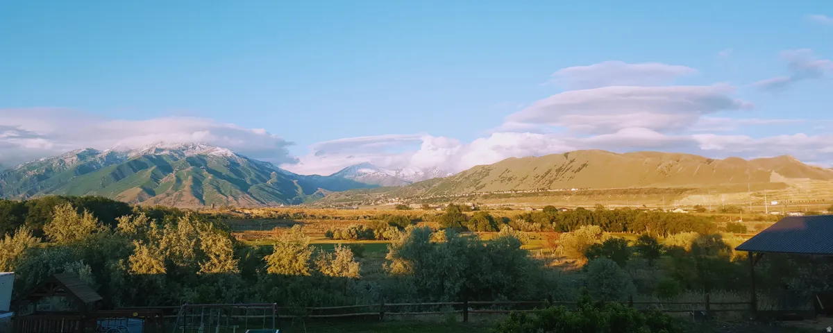 Expansive mountain range backdrop featuring snow-capped peaks