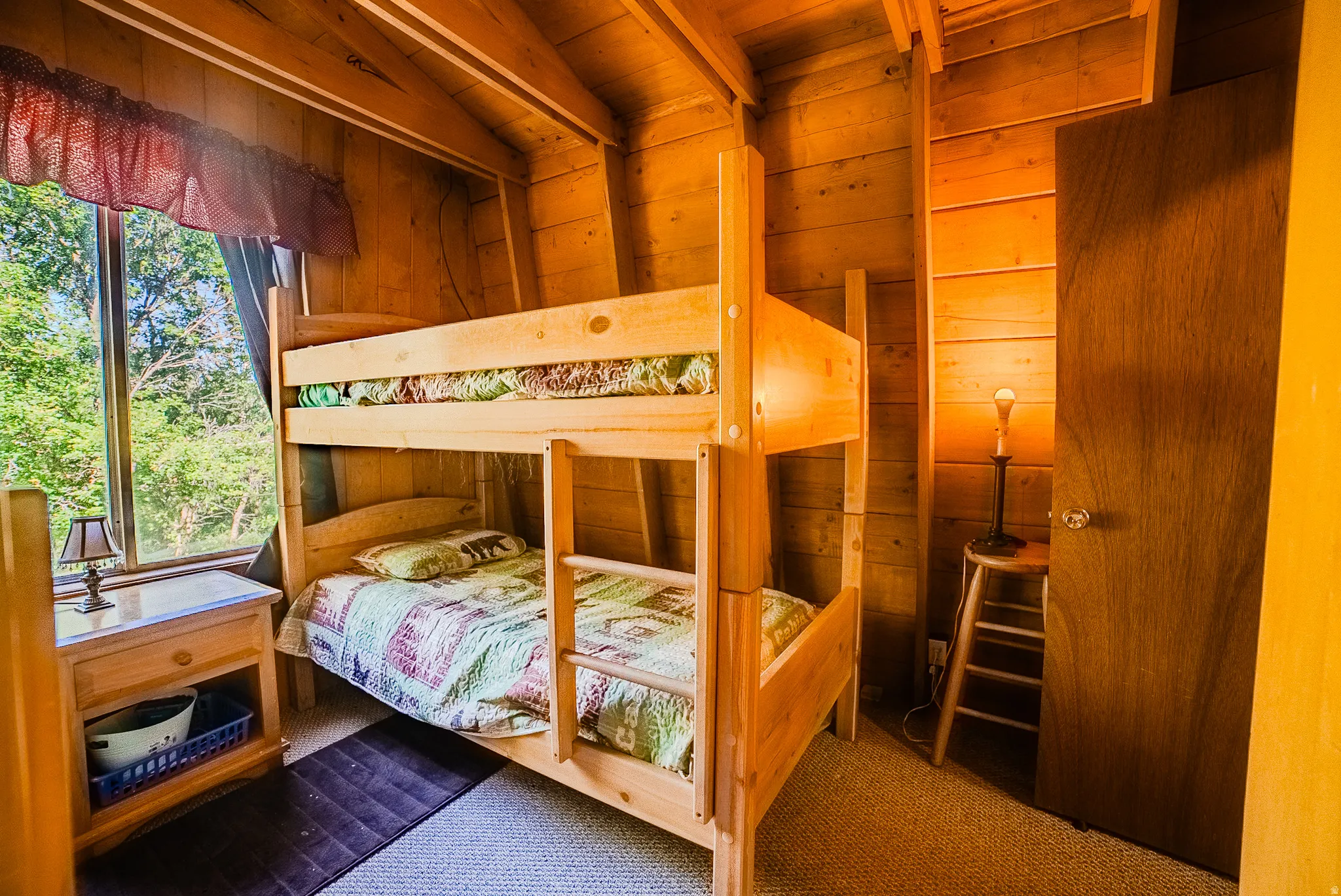 Pine-paneled walls and ceiling featuring exposed wood beams