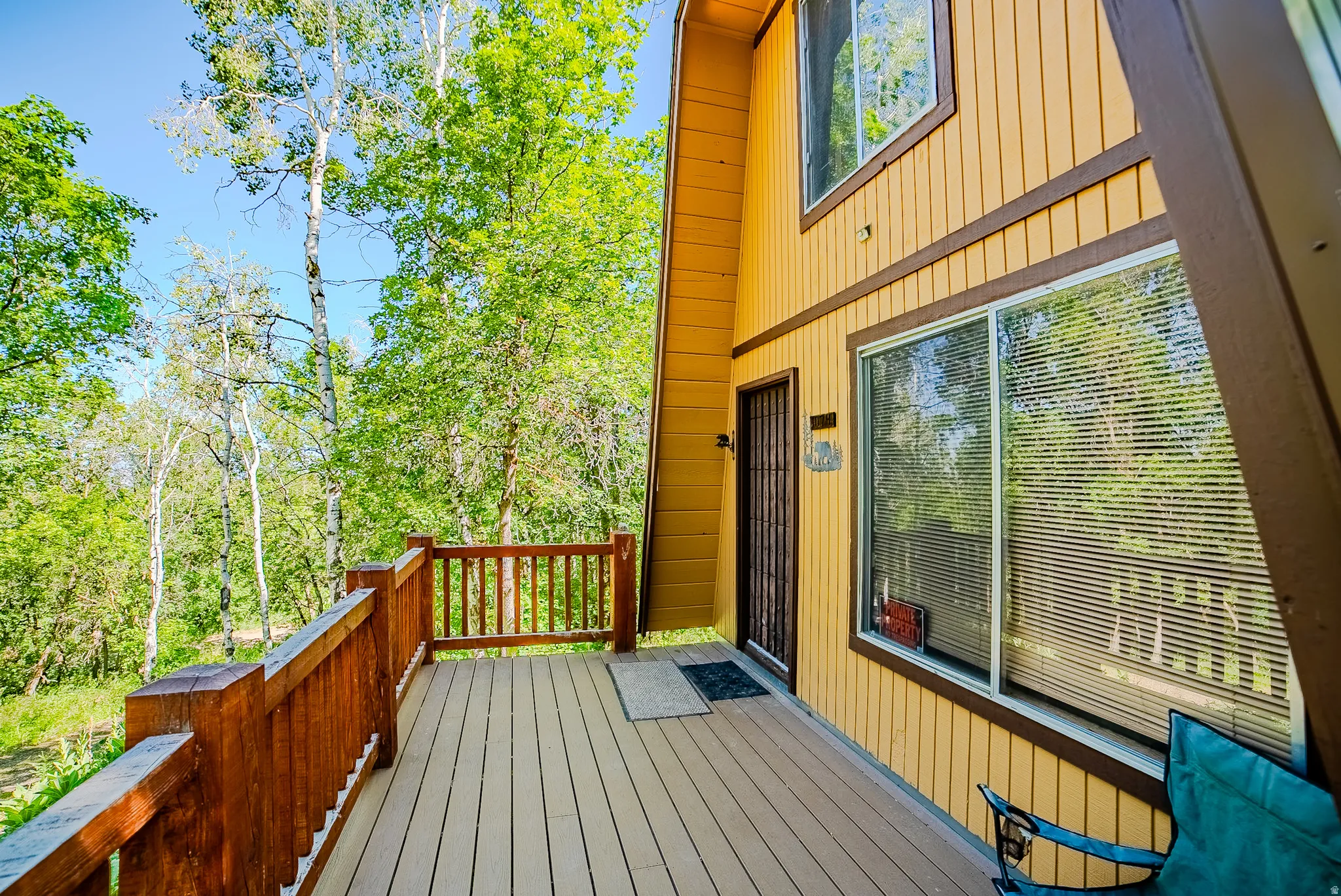 Spacious outdoor deck area featuring a wood-finish railing and durable decking
