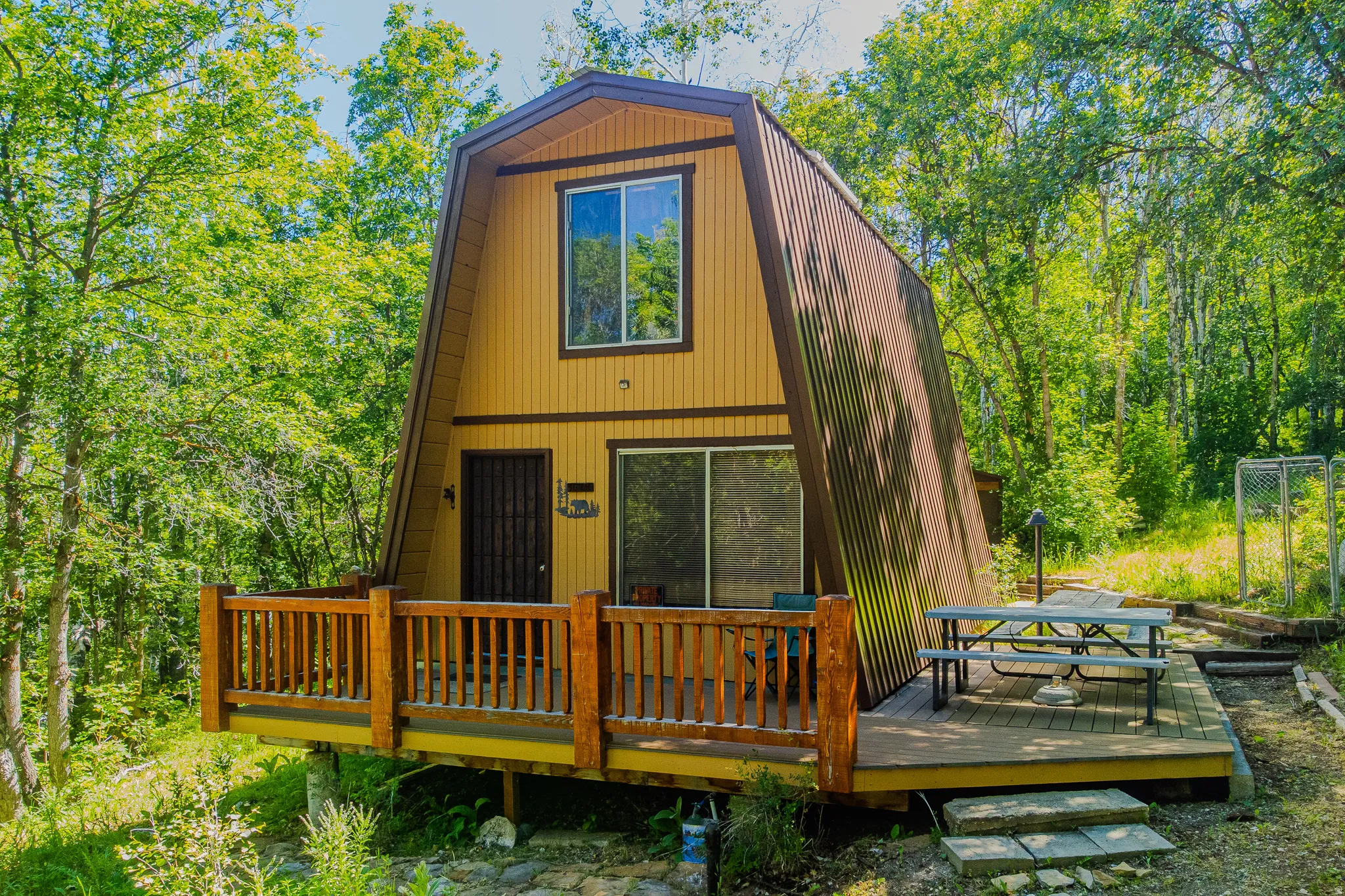 A-frame exterior with vertical siding and a corrugated metal roof
