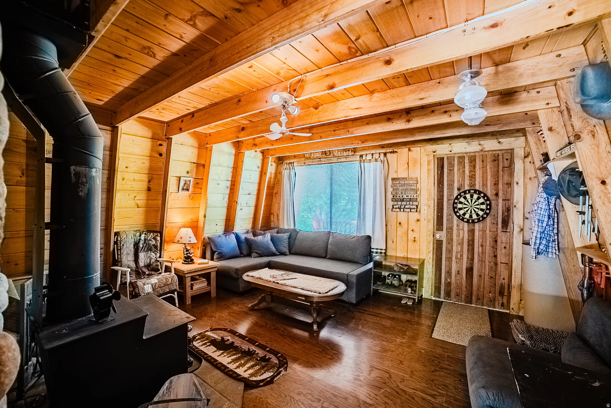 Living area featuring extensive wood-paneled walls and ceilings