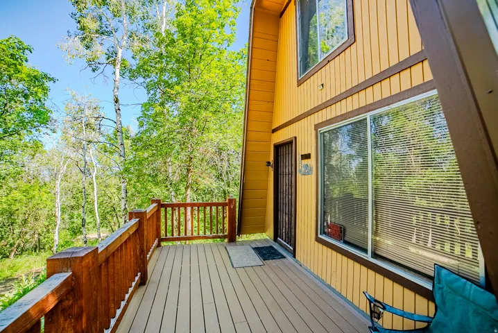 Spacious outdoor deck area featuring a wood-finish railing and durable decking