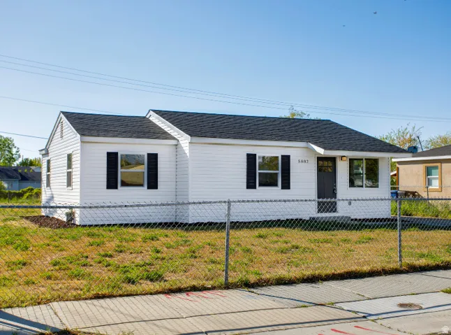 White siding exterior with a dark shingle roof