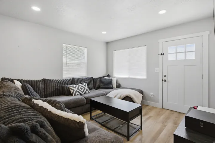 Bright living area featuring recessed lighting, light wood-finish flooring, and white walls