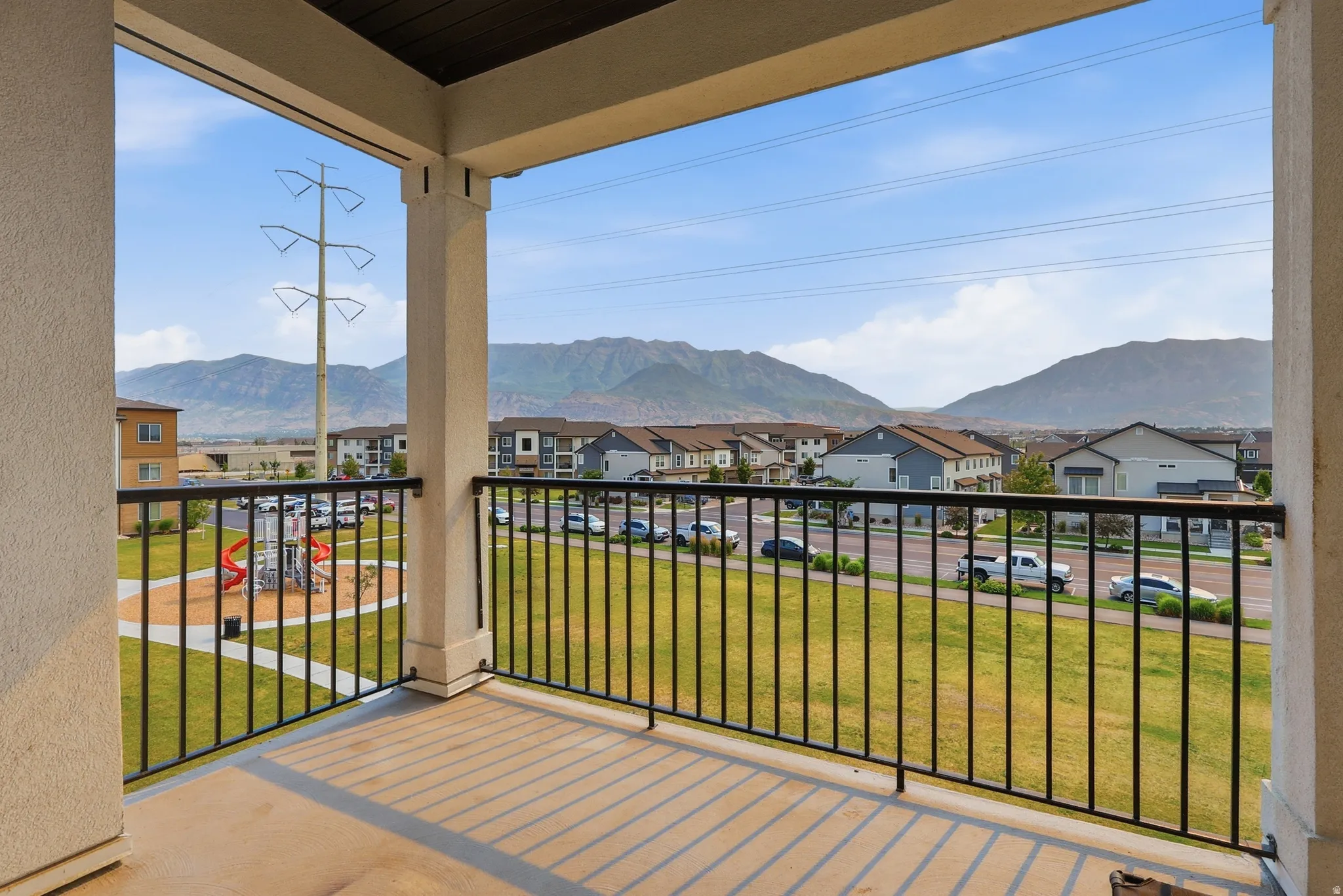 Balcony with concrete flooring and black metal railing