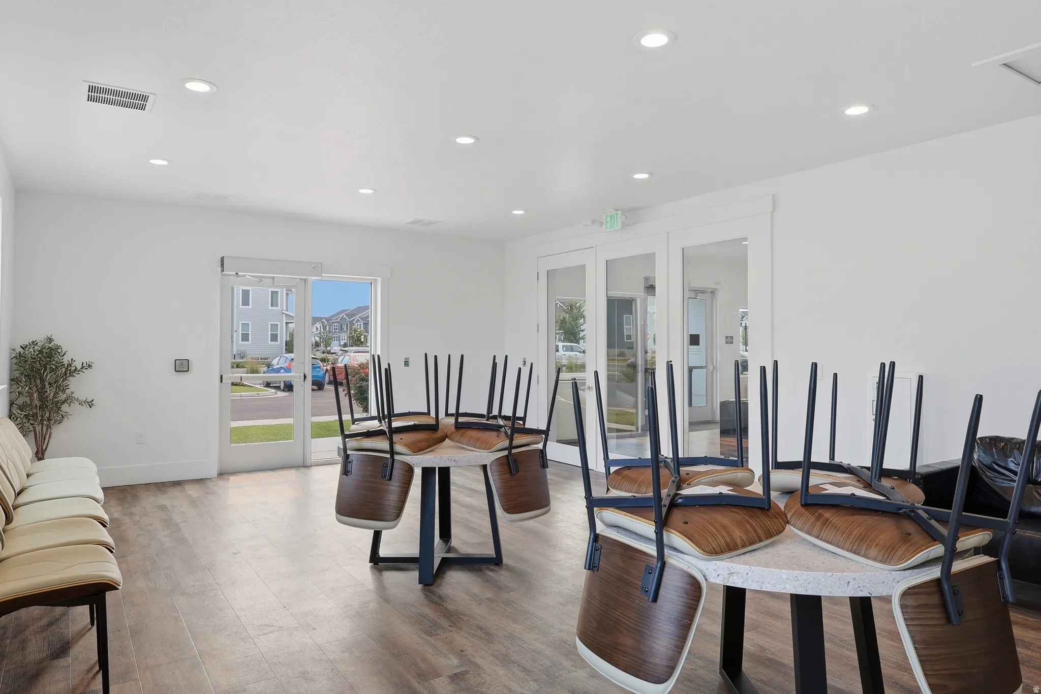 Open-concept common area featuring wood-finish flooring, recessed lighting, and white walls