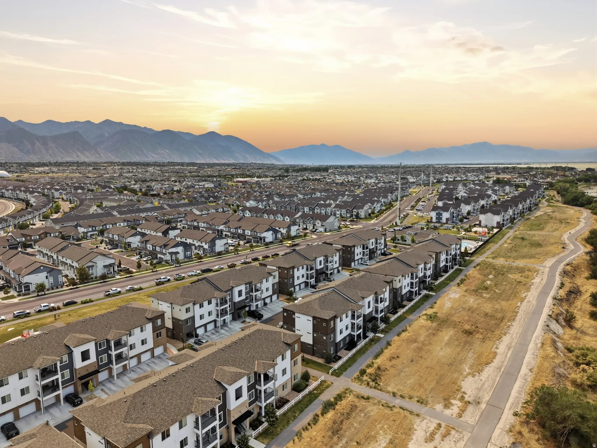 Expansive residential development featuring multi-story townhomes and apartment buildings