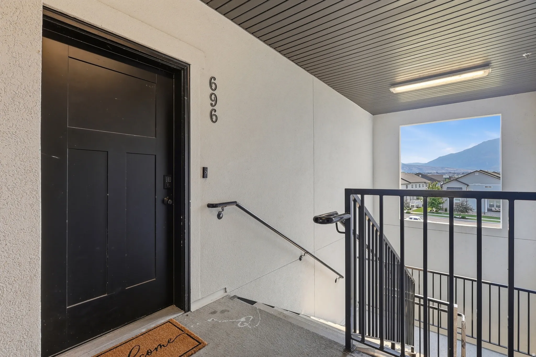 Contemporary black entry door with modern address numbering