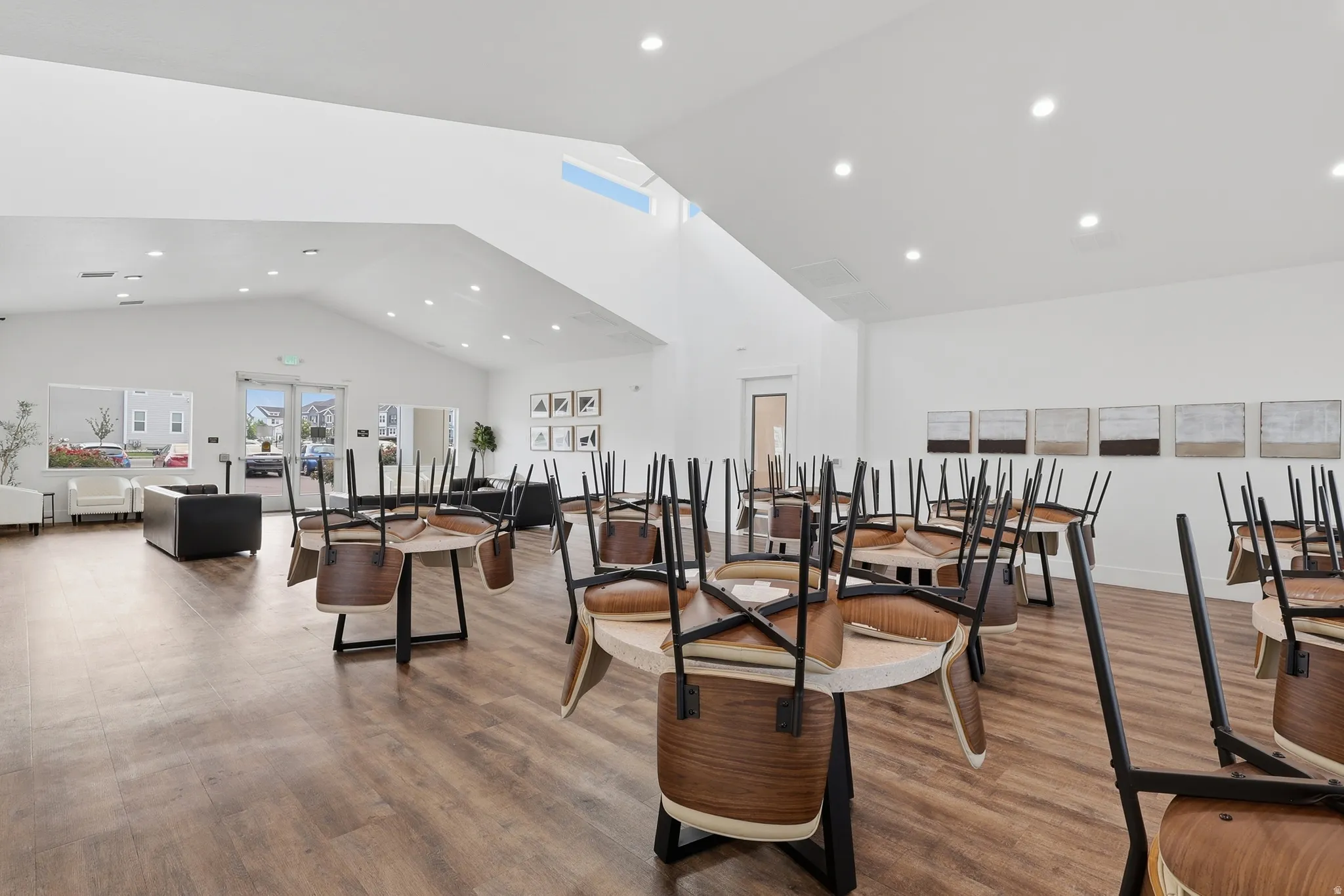 Spacious common area featuring wood-finish flooring, vaulted ceilings, and recessed lighting