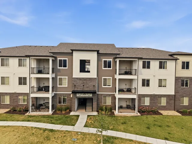 Contemporary multi-story building featuring a blend of neutral-toned siding and brick accents