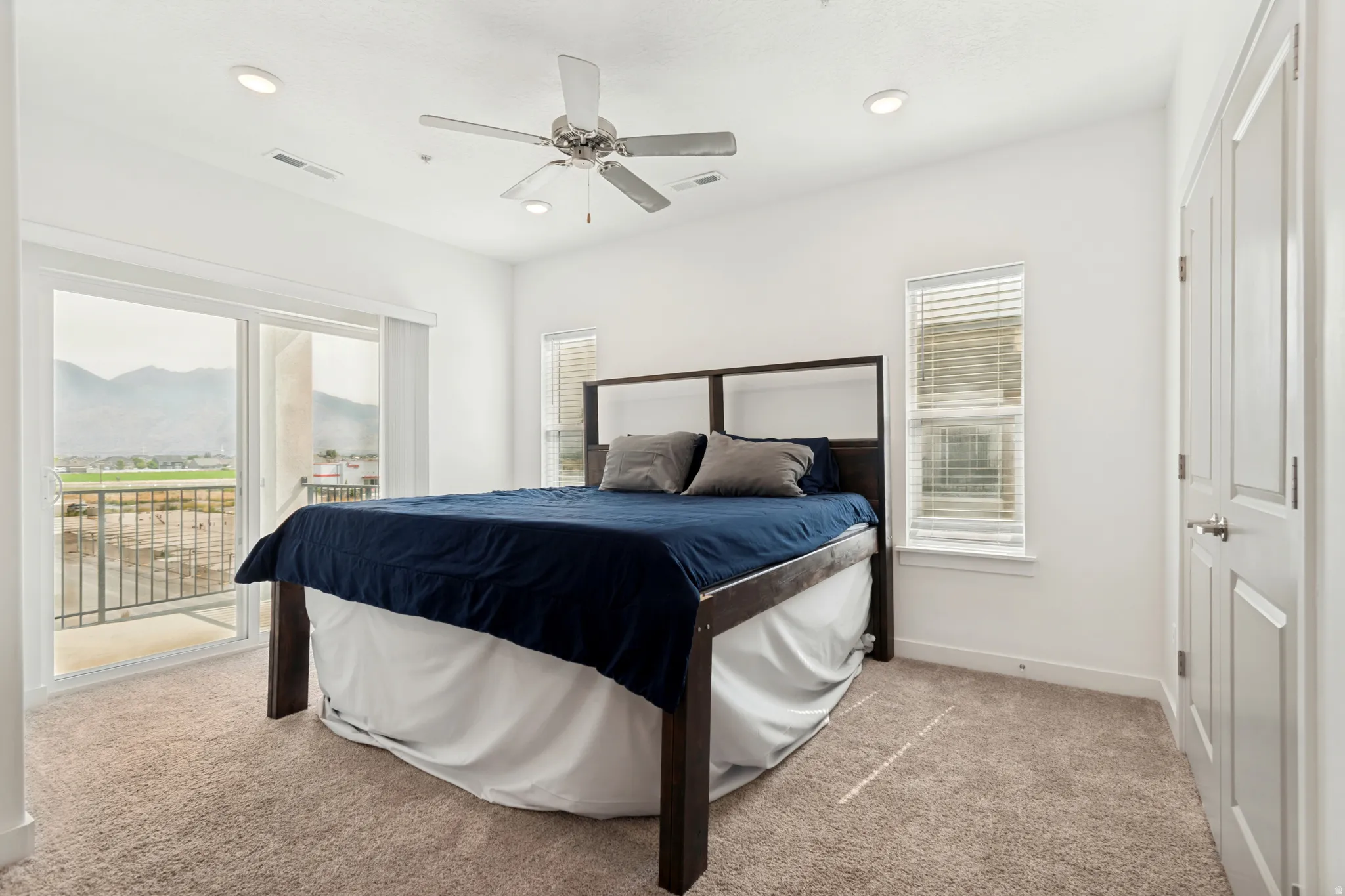 Bedroom 3. Carpeted room featuring a ceiling fan with integrated lighting, recessed ceiling lights, and white walls