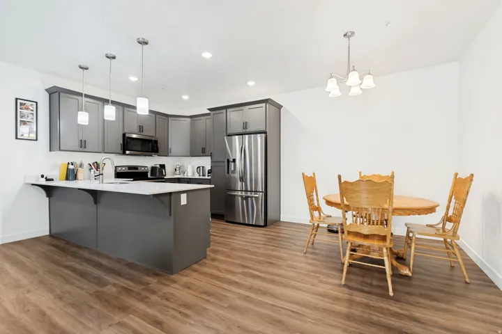 Open-concept kitchen and dining area with wood-finish flooring