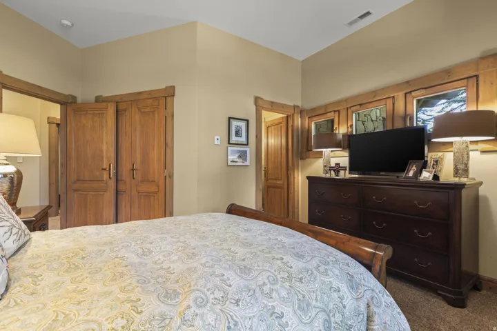 Bedroom featuring warm neutral wall tones and wood-finish trim