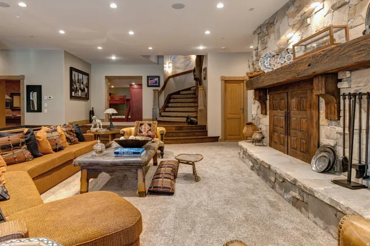 Stone fireplace with a substantial timber mantel and hearth