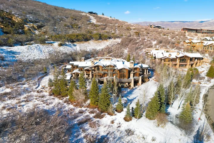 Expansive mountain property featuring a multi-level residence with extensive natural wood and stone detailing