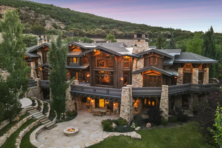 Multi-level mountain-style residence featuring extensive stone and wood cladding