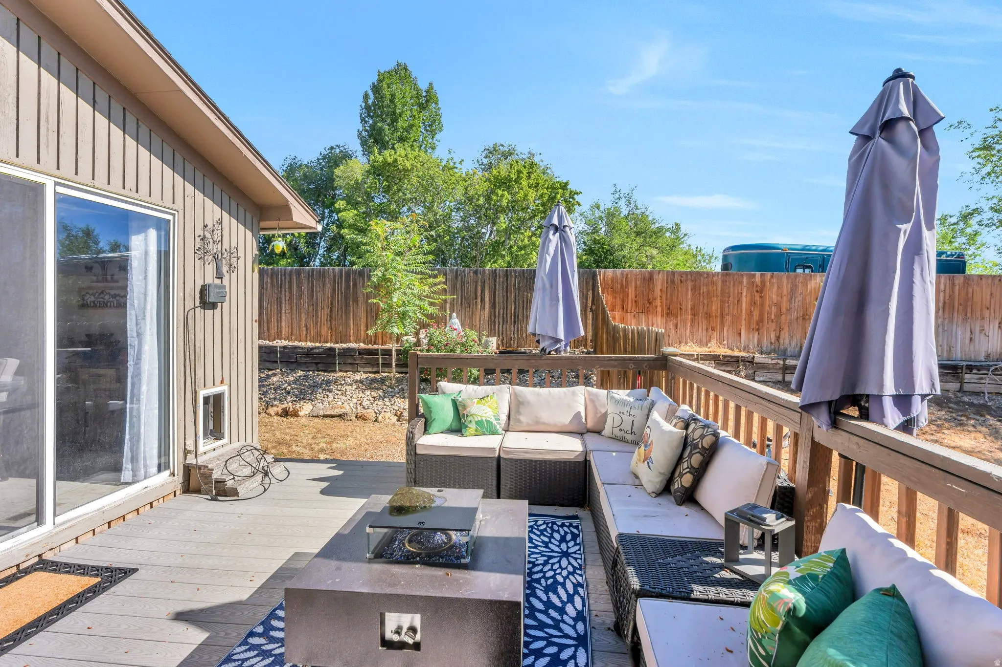 Expansive outdoor deck featuring wood-finish flooring and a wood railing