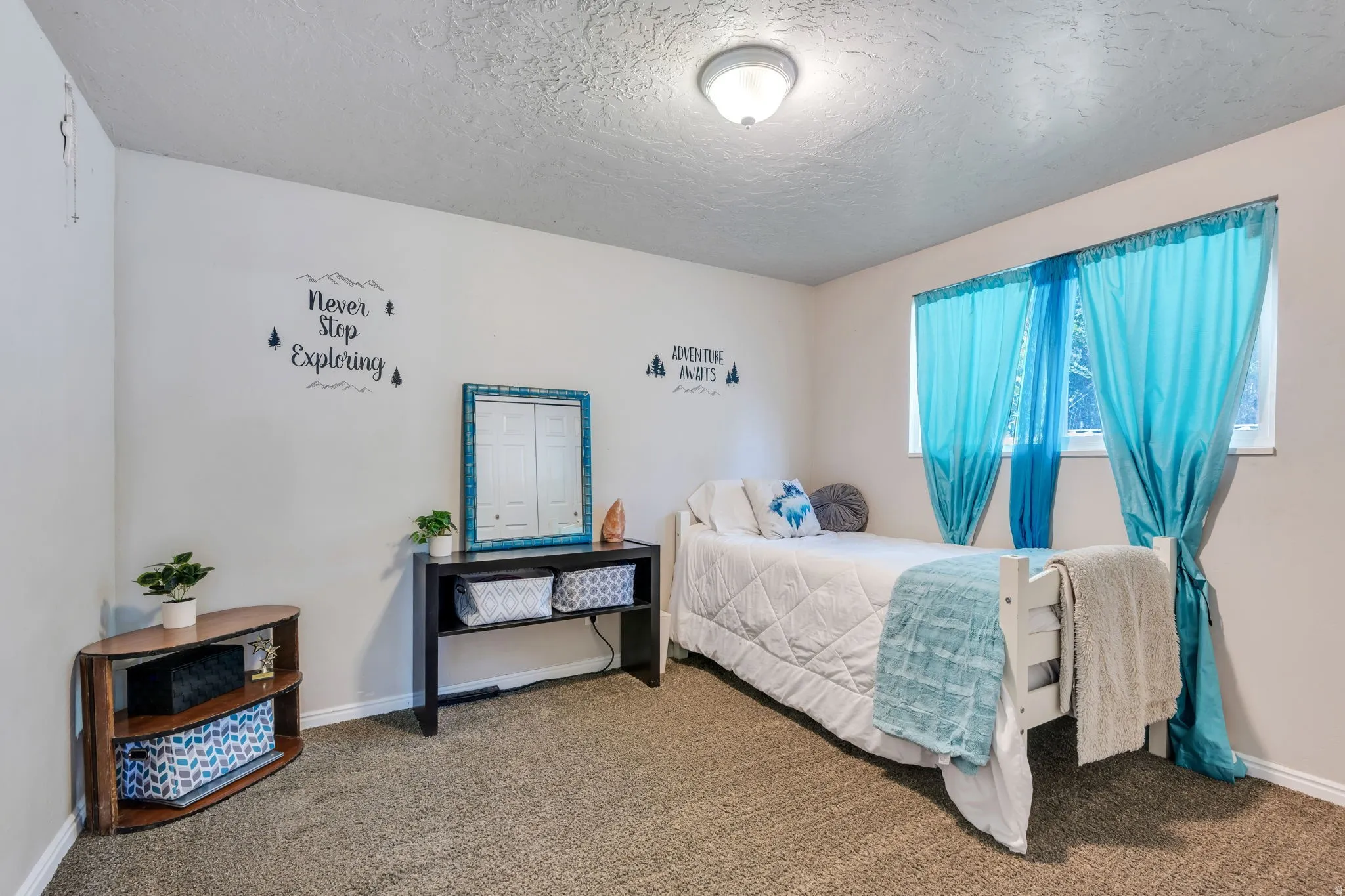 Carpeted bedroom featuring a single window, white trim, a flush-mount ceiling light fixture, and textured ceilings