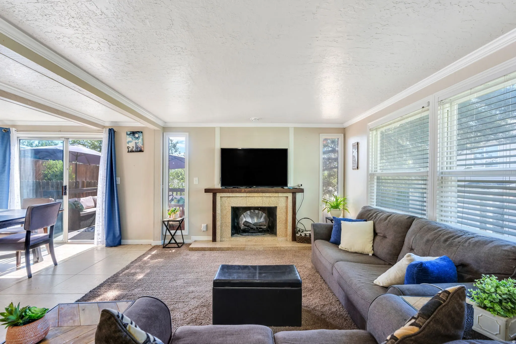 Living area with a fireplace featuring a stone surround and wood mantel
