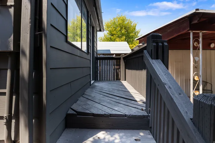 Rear Deck & Entrance to Mudroom / Laundry exterior featuring dark gray horizontal siding and a dark wood-finish deck