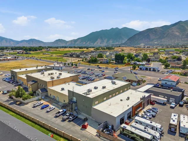 Expansive commercial property featuring multiple structures with flat roofs and ample parking