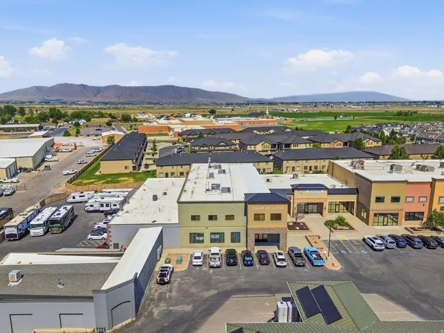 Commercial complex featuring multi-story buildings, flat and pitched roofs, and ample surface parking