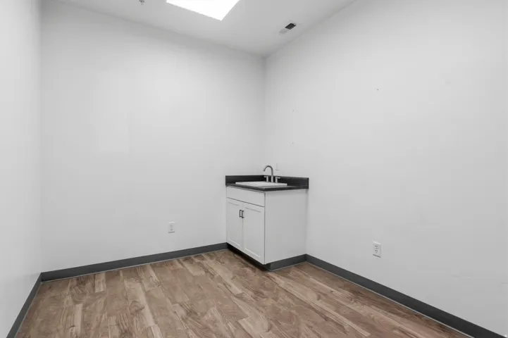Compact vanity with a dark countertop and undermount sink