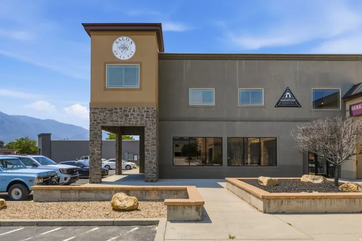 Commercial building exterior featuring a stone and stucco facade