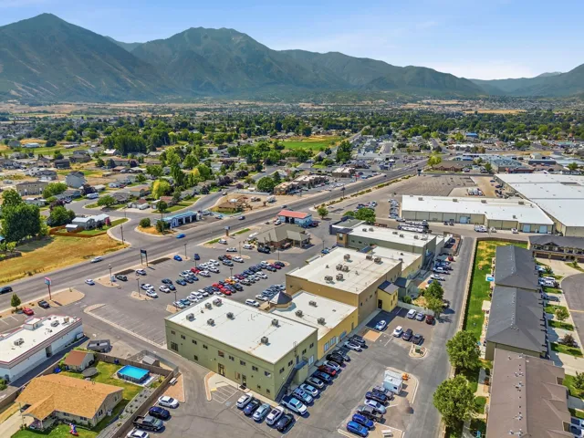 Aerial perspective showcasing multiple commercial buildings with ample paved parking areas