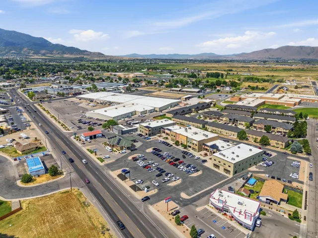 Expansive commercial property featuring multiple retail buildings and extensive paved parking areas