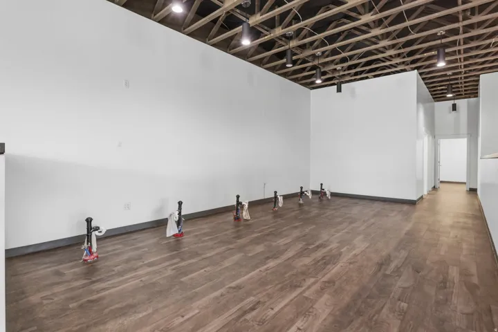 Spacious interior featuring wood-finish flooring, exposed ceiling joists, and track lighting