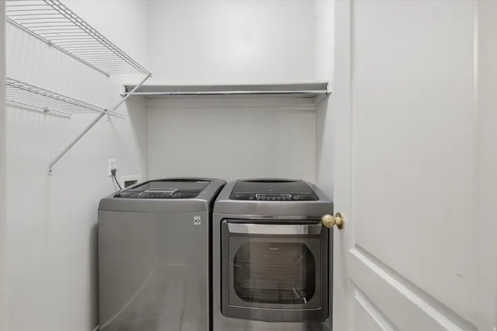 Dedicated laundry area featuring wire shelving, a clothing rod, and neutral wall tones