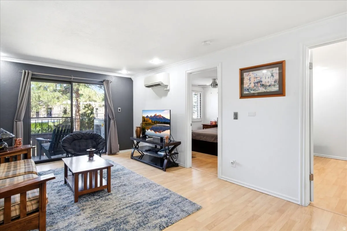 Living area featuring wood-finish flooring and a private outdoor balcony
