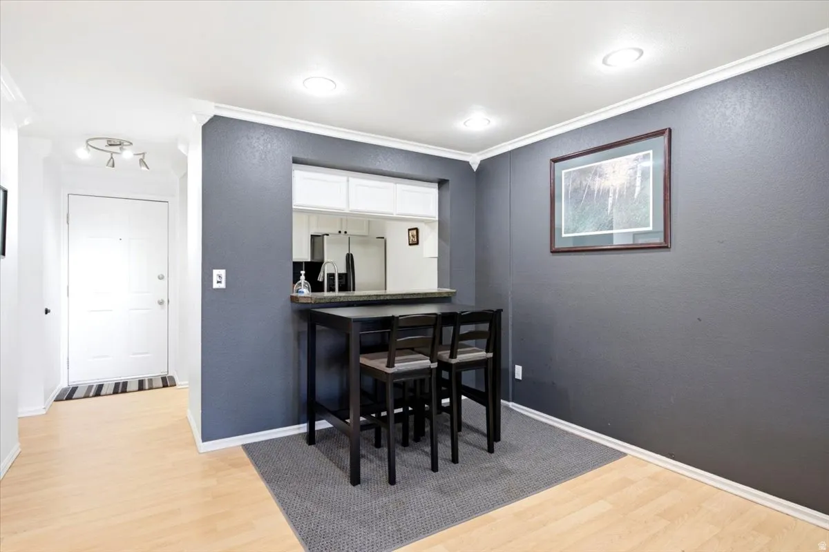 Dining area featuring a pass-through window to the kitchen.