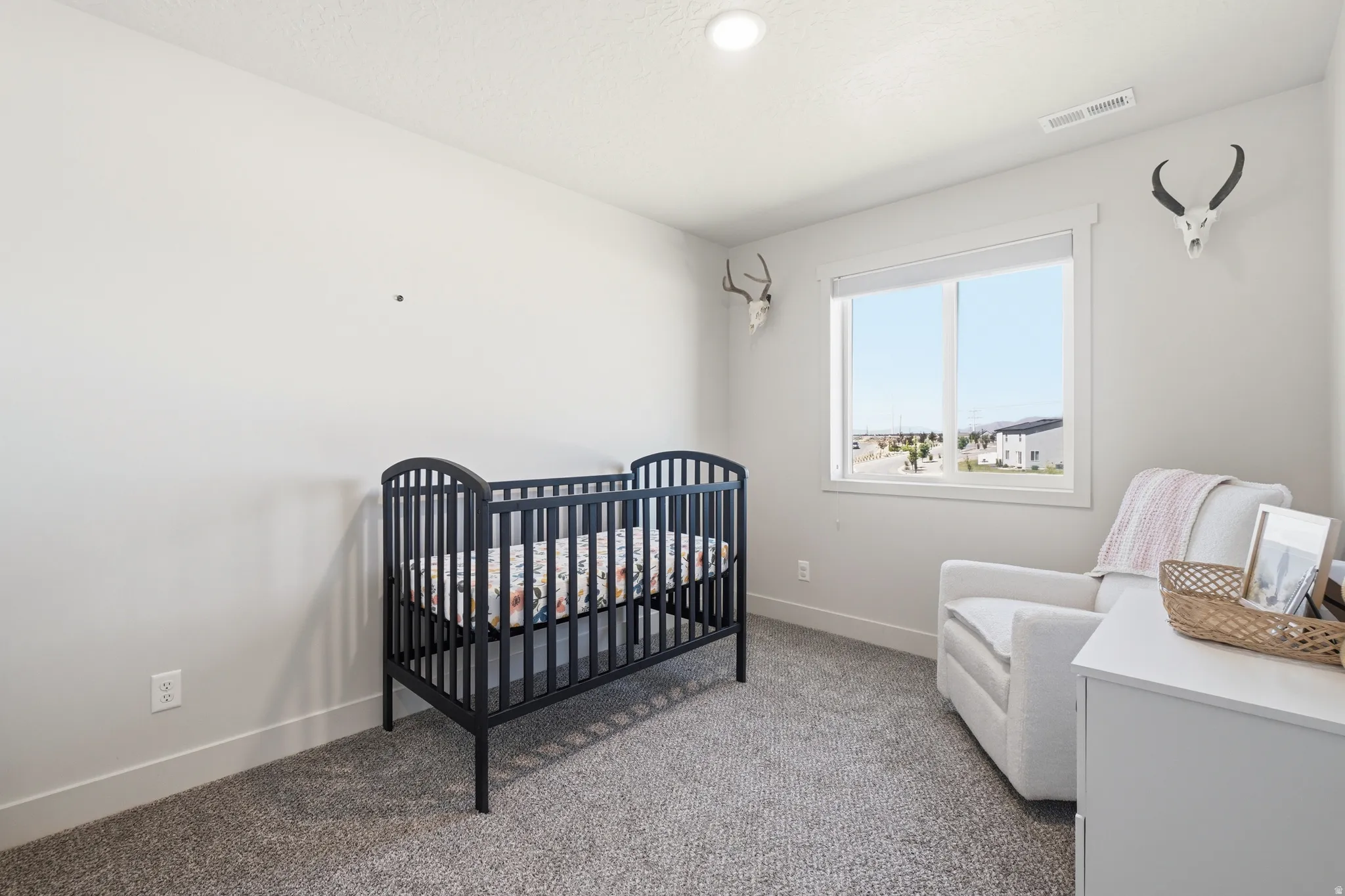 Light-filled interior space featuring neutral wall tones, recessed lighting, and a large window