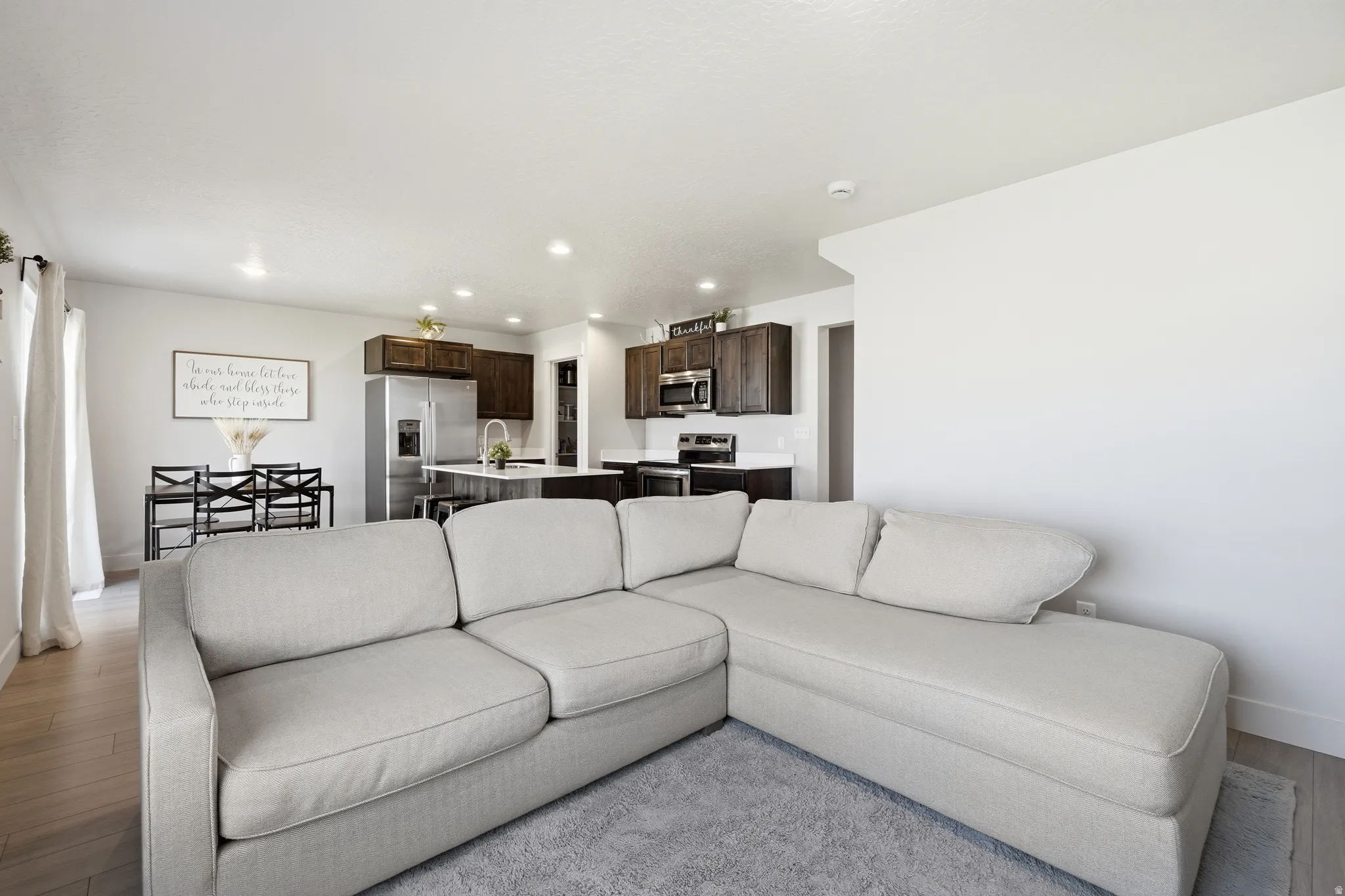 Open-concept living area featuring light wood-finish flooring