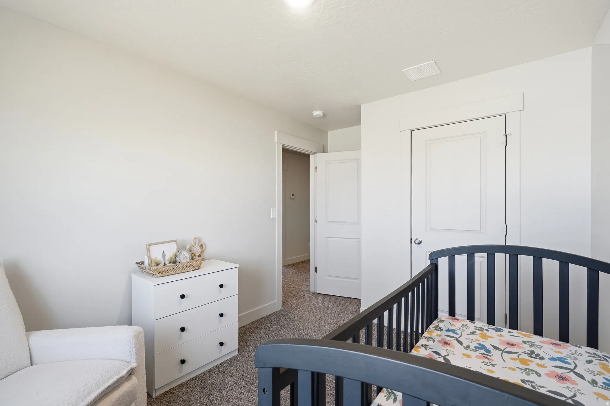 Neutral wall paint, light-colored carpet flooring, white trim, and white paneled doors