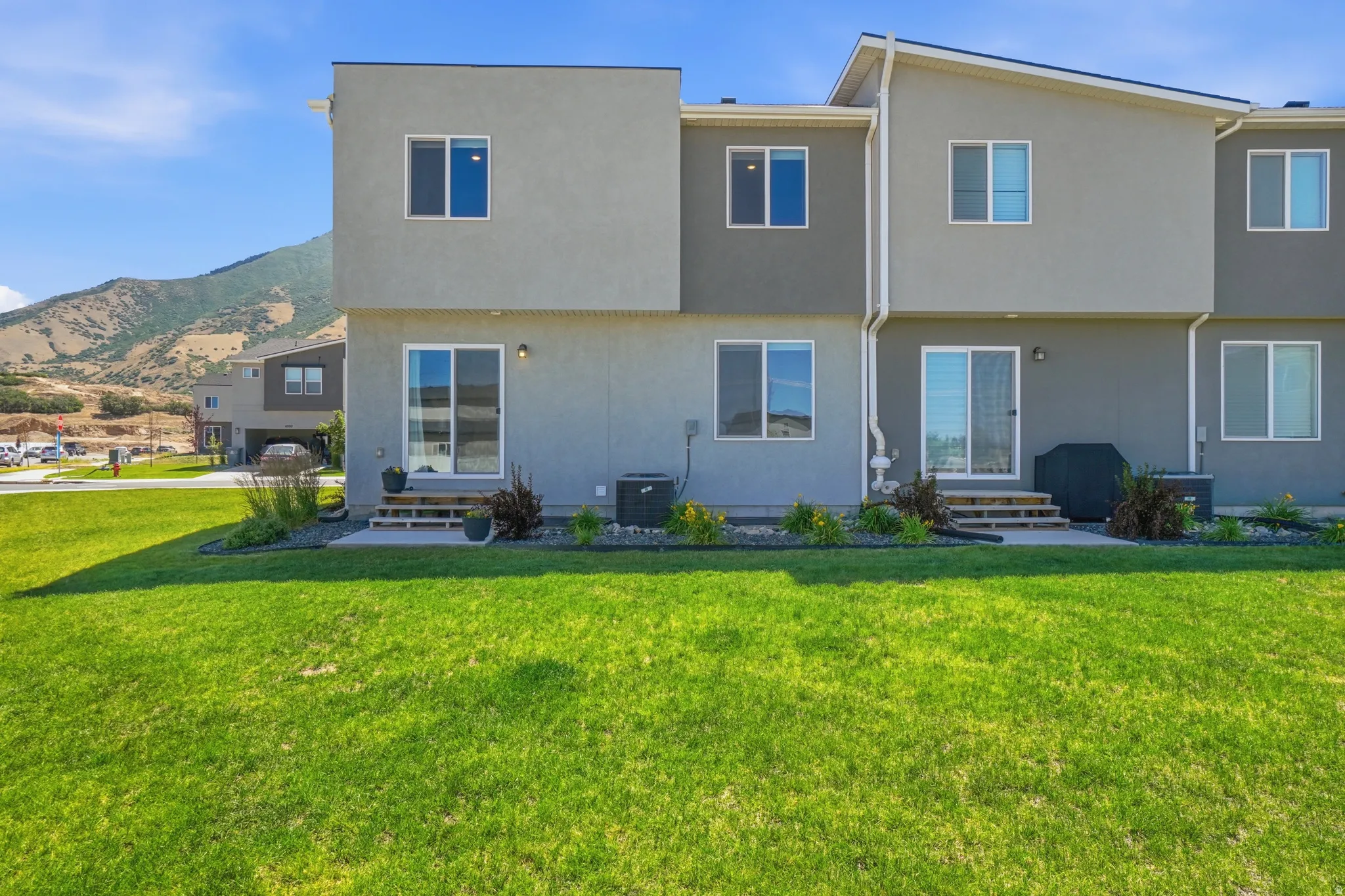 Expansive green lawn with mountain backdrop