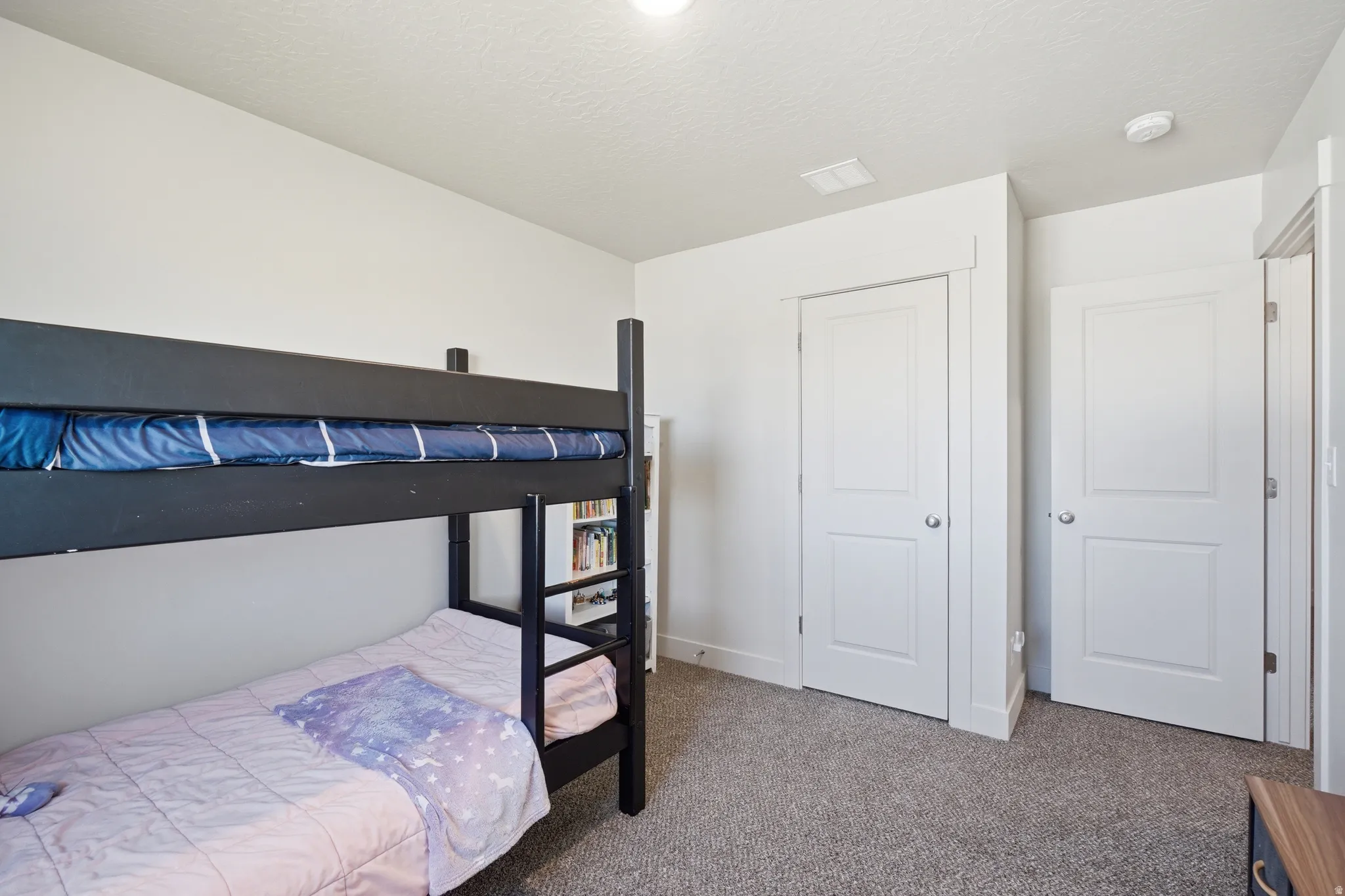 Carpeted room with a built-in bookshelf