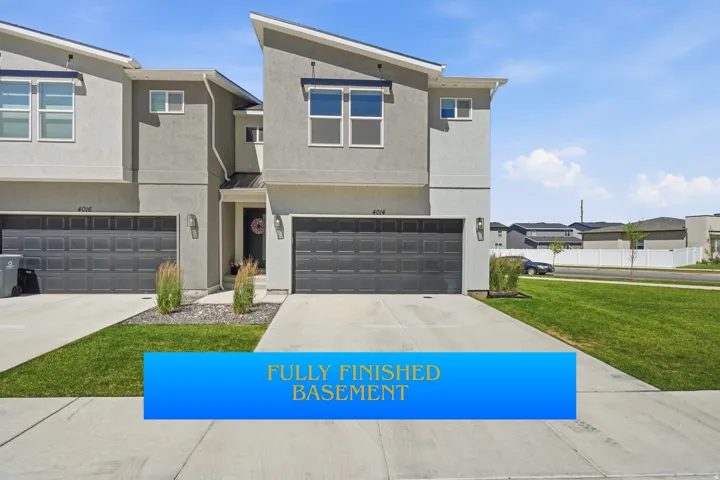 Contemporary townhome exterior featuring a stucco finish