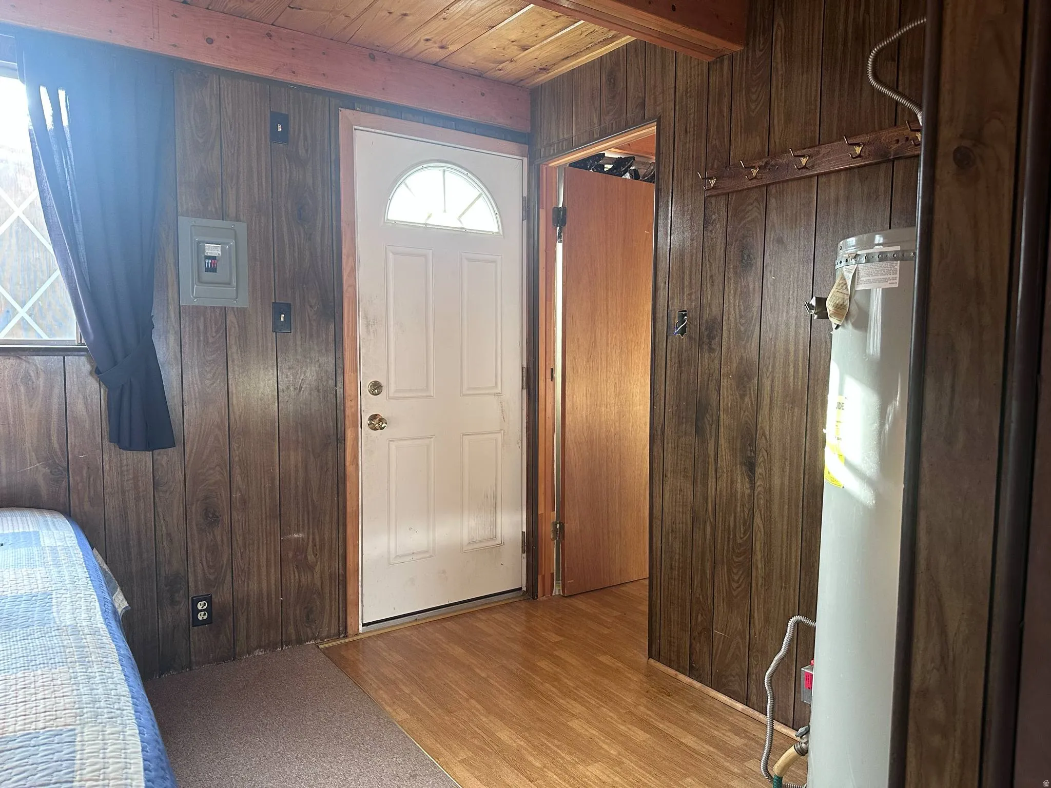 Interior space featuring wood-finish paneling, a wood plank ceiling, and wood-finish flooring