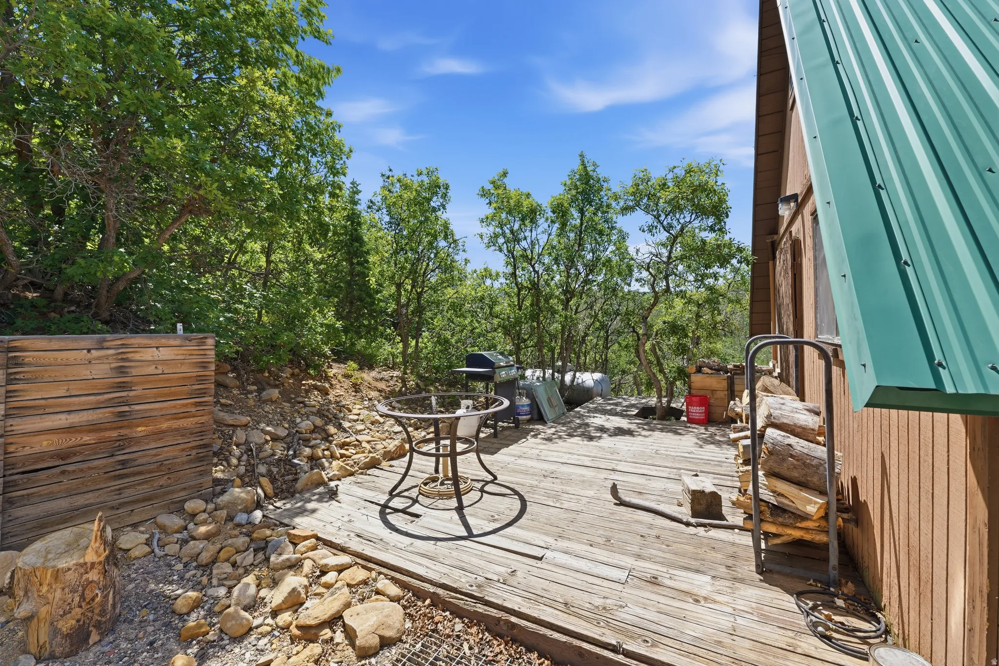 Expansive wood-plank deck with a surrounding natural rock landscape