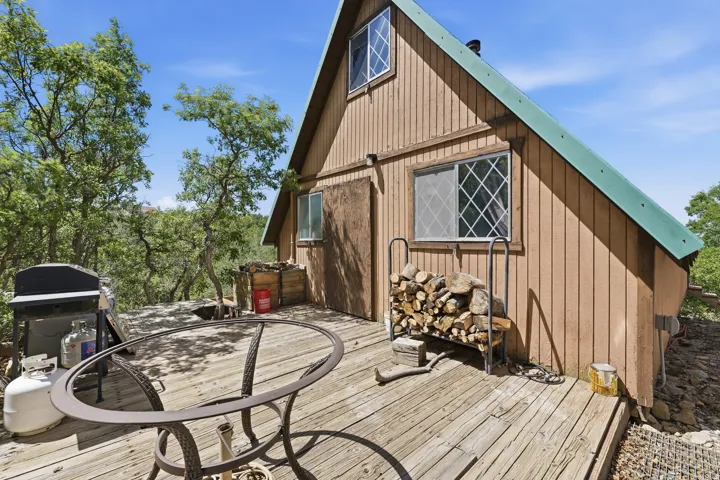 Exterior A-frame style residence with vertical wood siding and a green sloped roof