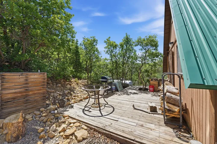 Expansive wood-plank deck with a surrounding natural rock landscape