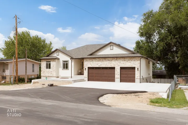 Contemporary ranch-style exterior featuring stone veneer and stucco finishes