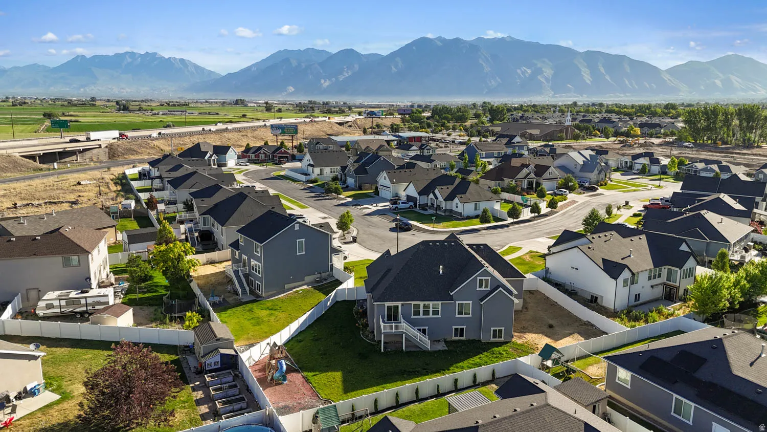 Contemporary subdivision featuring homes with varying exterior finishes and asphalt shingle roofs
