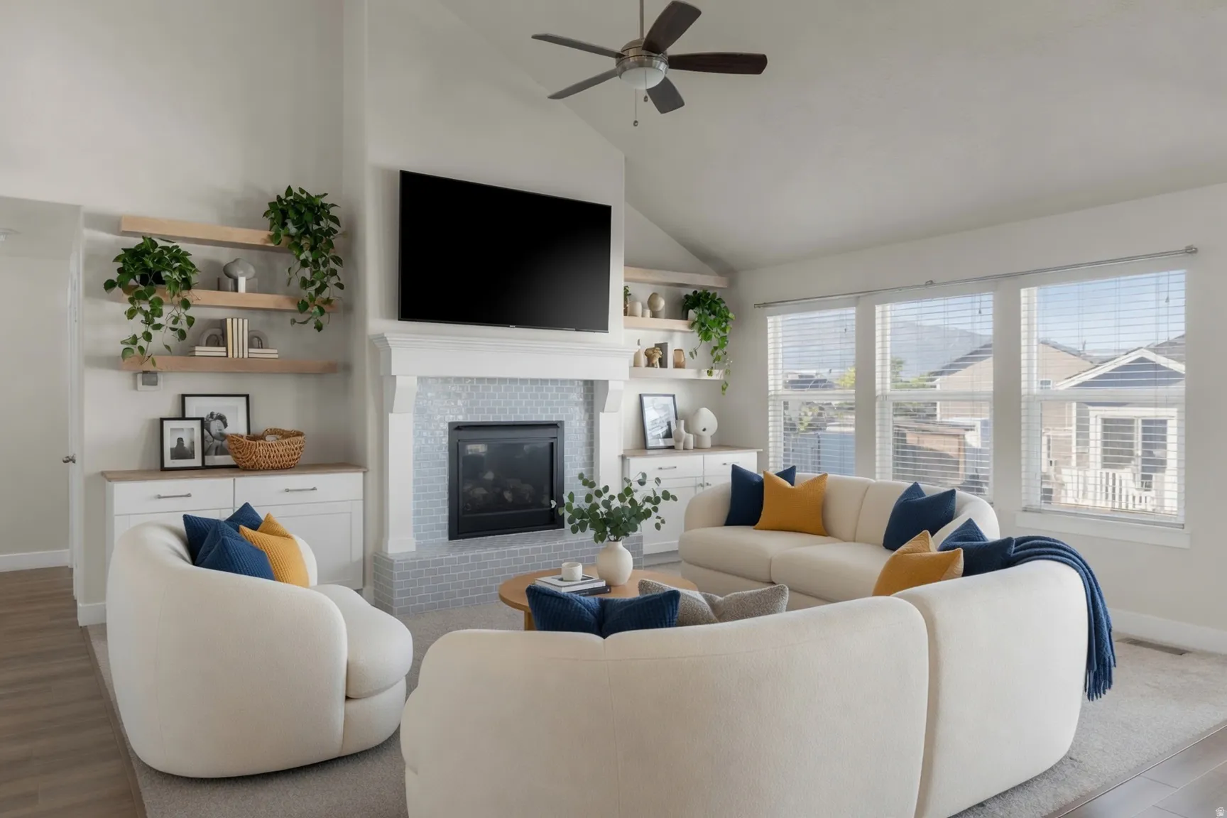 Living area featuring a vaulted ceiling with a ceiling fan