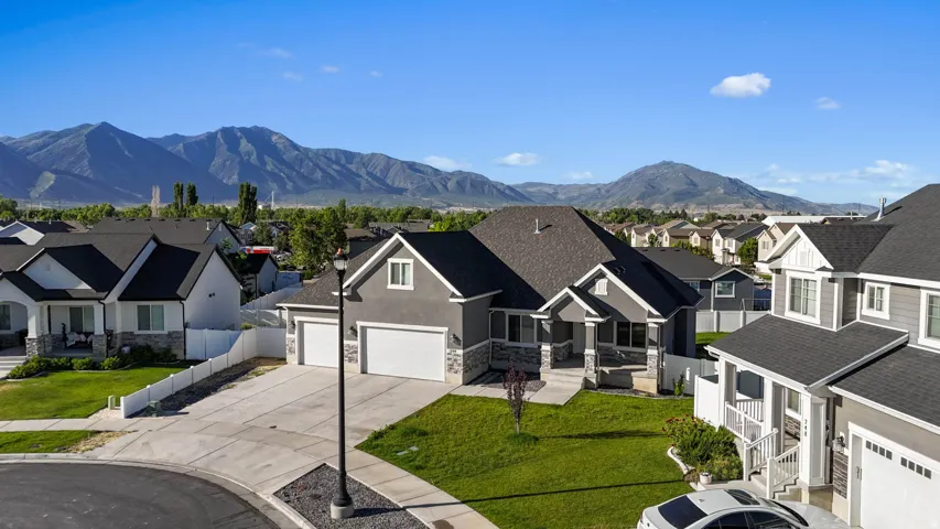 Contemporary home exterior with a gray facade, white trim, and stone accents