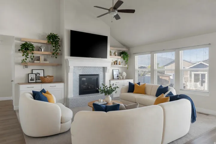 Living area featuring a vaulted ceiling with a ceiling fan
