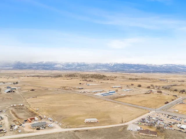 Expansive land parcel featuring open fields and distant snow-capped mountains